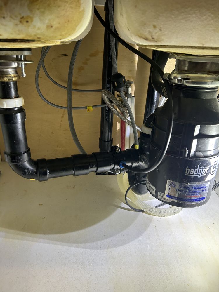 Badger 5 disposal close-up — double sink plumbing setup